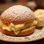 Delicious Kirschmichel dessert garnished with powdered sugar and vanilla ice cream, perfect for dessert lovers.